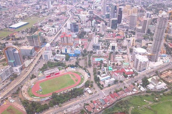 Addis Ababa from the air, its low roofs running out to towers and a stadium